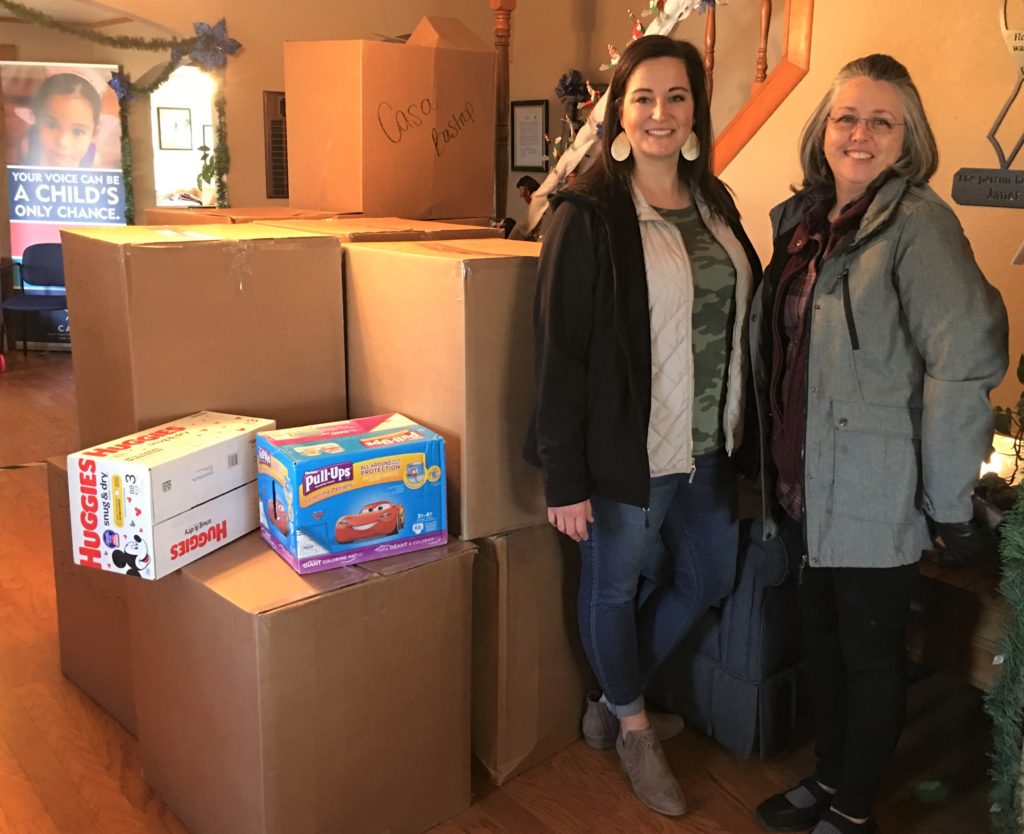 Brandi Taylor and Barbara Gerhart representing Bluebonnet Electric Cooperative delivering boxes and boxes of backpacks and diapers.